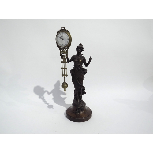 8080 - A Junghans figural form spelter mystery clock, with spare clock case, on wooden plinth, figure is 29... 