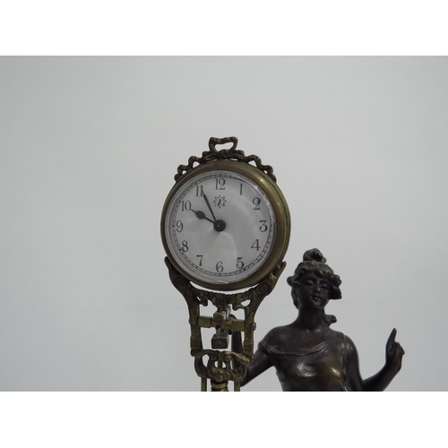 8080 - A Junghans figural form spelter mystery clock, with spare clock case, on wooden plinth, figure is 29... 