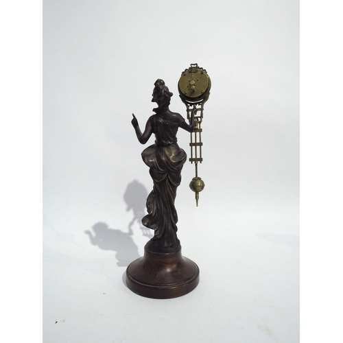 8080 - A Junghans figural form spelter mystery clock, with spare clock case, on wooden plinth, figure is 29... 