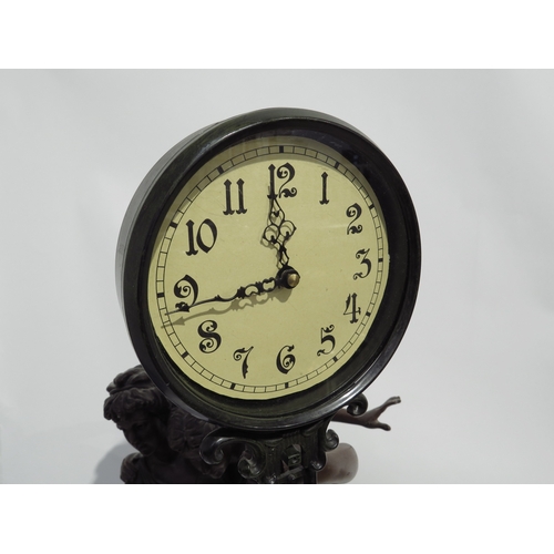 8065 - A large reproduction bronze effect figural mystery clock with quartz movement, 78cm tall