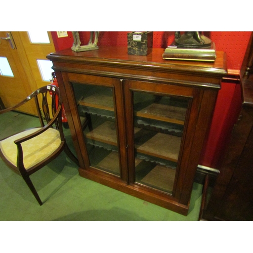 4029 - A late Victorian walnut bookcase with height adjustable shelves having leather dust protectors. The ... 