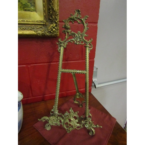 4179 - A brass easel, 54cm tall