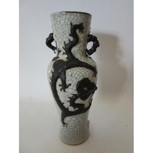 1374 - A Japanese crackle ware vase with black relief of dragon, character marks to base, 25cm tall