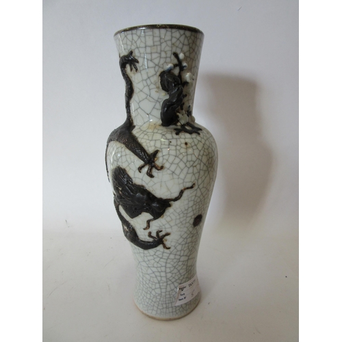 1374 - A Japanese crackle ware vase with black relief of dragon, character marks to base, 25cm tall