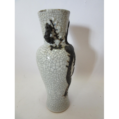 1374 - A Japanese crackle ware vase with black relief of dragon, character marks to base, 25cm tall