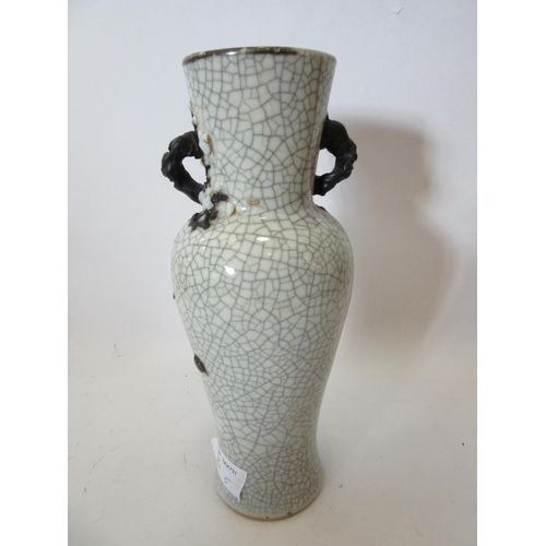 1374 - A Japanese crackle ware vase with black relief of dragon, character marks to base, 25cm tall