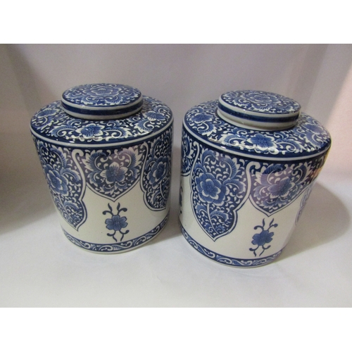 4259 - A pair of 20th Century Oriental style blue and white jars and covers, 25cm tall