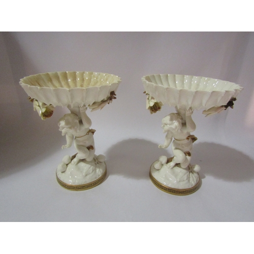 4271 - A pair of Moore Brothers porcelain comports surmounted by cherubs, gilt Greek key design, 20cm tall