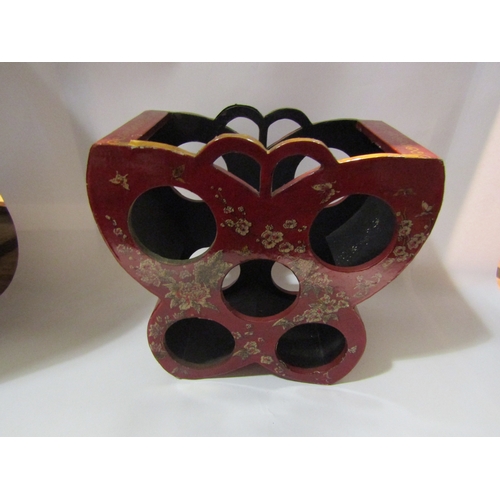 4275 - A red lacquer style six wine bottle stand with blossom and butterfly decoration, 33cm tall