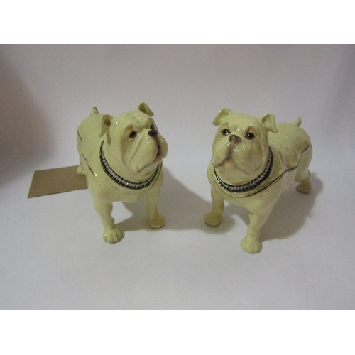 4287 - A pair of enamel bulldogs as trinket boxes, wearing diamante collars, 13cm x 20cm