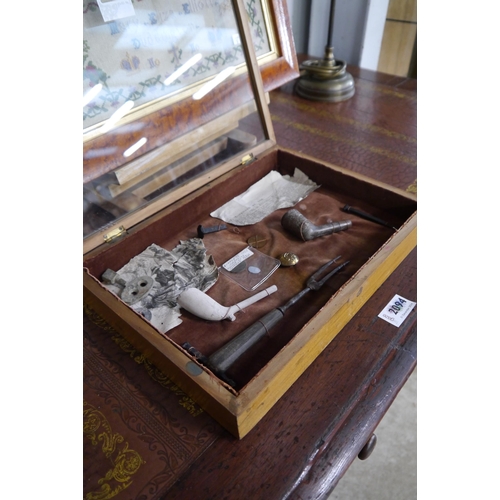 A small glazed curios cabinet and contents