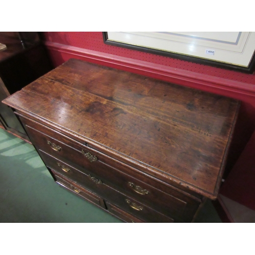 4045 - An 18th Century provincial oak chest, the hinged lid over two faux drawers and two short base drawer... 