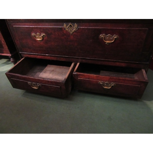 4045 - An 18th Century provincial oak chest, the hinged lid over two faux drawers and two short base drawer... 