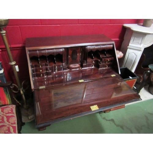 4165 - A George III style mahogany bureau with a fully fitted interior over four drawers on bracket feet (w... 