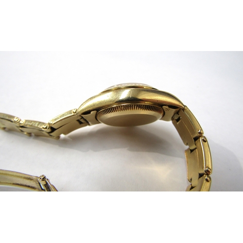 8174 - ROLEX: A Rolex Oyster Perpetual lady's 18ct gold cased wristwatch on an 18ct gold bracelet, gilded d... 