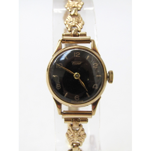 8186 - TISSOT: A 9ct gold case Tissot lady's wristwatch, black dial with Arabic numerals, 14g total weight