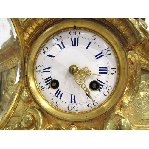 8063 - A 19th Century French gilt metal mantel clock, scroll and shell form design with white enamel and bl... 