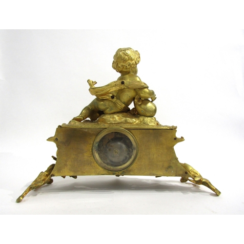 8063 - A 19th Century French gilt metal mantel clock, scroll and shell form design with white enamel and bl... 