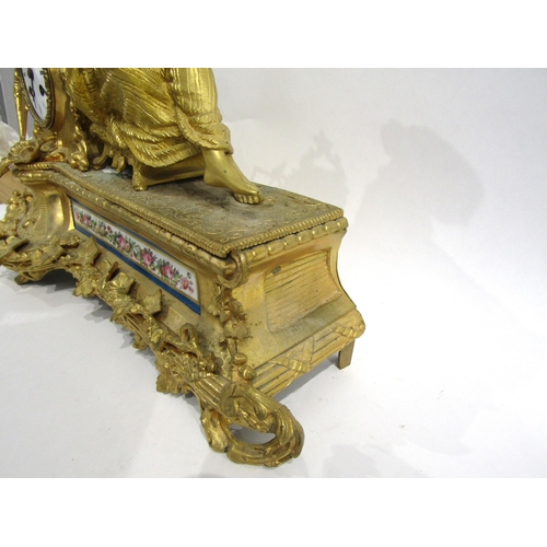 8062 - A French gilt metal mantel clock, leaf decorated base with porcelain floral design panels, surmounte... 