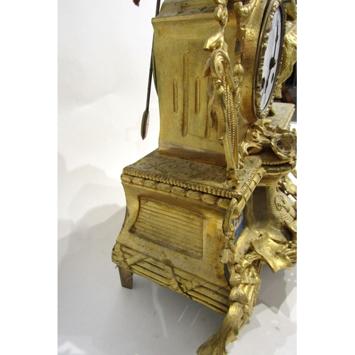 8062 - A French gilt metal mantel clock, leaf decorated base with porcelain floral design panels, surmounte... 