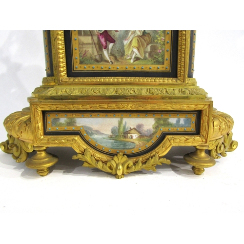 8051 - A 19th Century French gilt metal mantel clock, various waterside and village scene panels, with cent... 