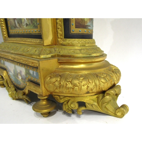 8051 - A 19th Century French gilt metal mantel clock, various waterside and village scene panels, with cent... 