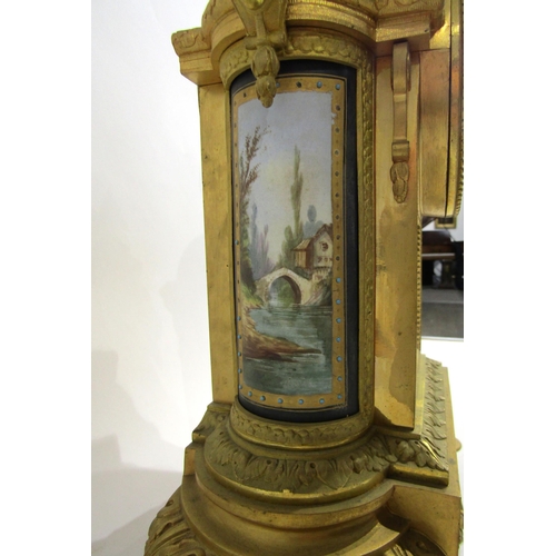 8051 - A 19th Century French gilt metal mantel clock, various waterside and village scene panels, with cent... 