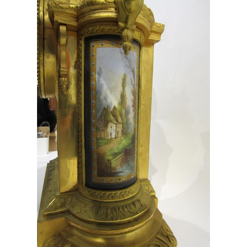 8051 - A 19th Century French gilt metal mantel clock, various waterside and village scene panels, with cent... 