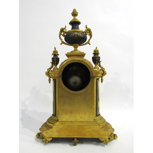 8051 - A 19th Century French gilt metal mantel clock, various waterside and village scene panels, with cent... 