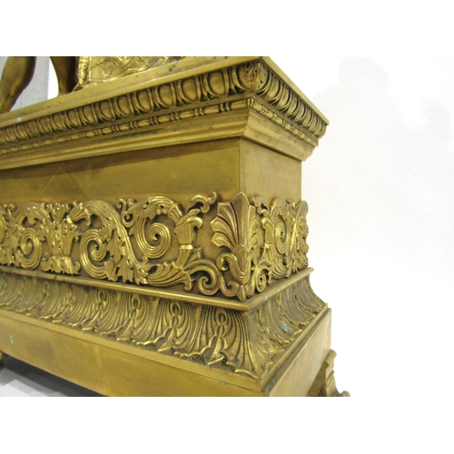 8043 - A large 19th Century gilt metal mantel clock, he ornate scroll design base surmounted by a distingui... 