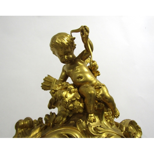 8042 - A large Rococo Louis XV style ormolu/gilt metal mantel clock, ornate design with central green man a... 