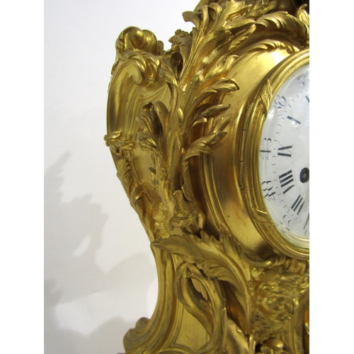 8042 - A large Rococo Louis XV style ormolu/gilt metal mantel clock, ornate design with central green man a... 