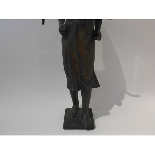 6103 - A 19th Century bronze of a field girl in the style of Millet, standing holding a rake behind her bac... 