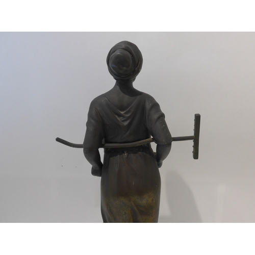 6103 - A 19th Century bronze of a field girl in the style of Millet, standing holding a rake behind her bac... 