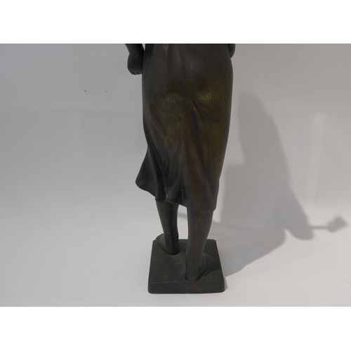 6103 - A 19th Century bronze of a field girl in the style of Millet, standing holding a rake behind her bac... 