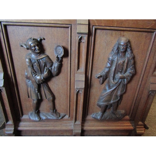 1030 - A late 19th Century oak shop counter, heavily carved figures to front section, linen fold door to si... 