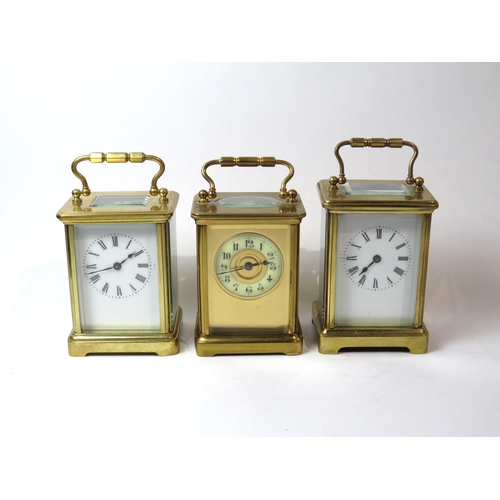 8106 - Three brass cased carriage timepieces, one with a gilt front plate with cream enamel Arabic chapter ... 