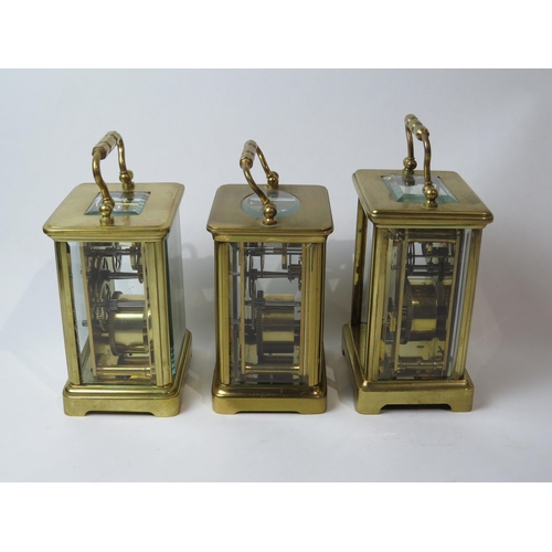 8106 - Three brass cased carriage timepieces, one with a gilt front plate with cream enamel Arabic chapter ... 