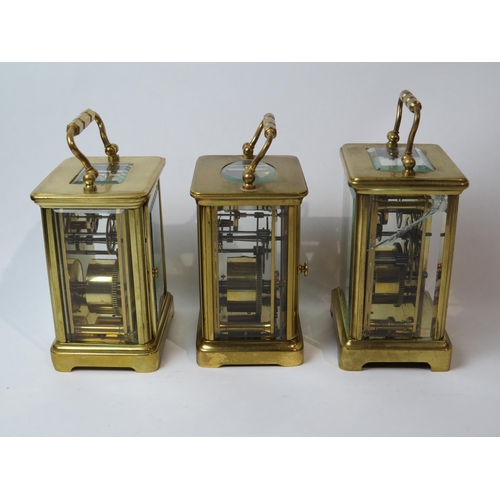 8106 - Three brass cased carriage timepieces, one with a gilt front plate with cream enamel Arabic chapter ... 