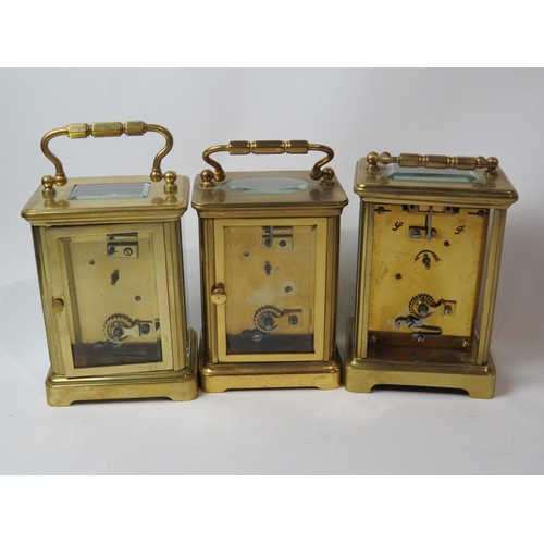 8106 - Three brass cased carriage timepieces, one with a gilt front plate with cream enamel Arabic chapter ... 