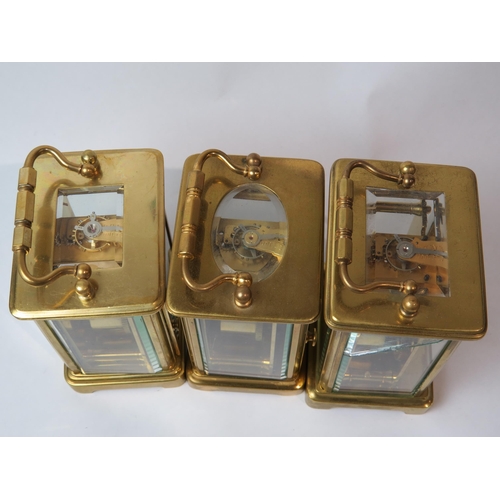 8106 - Three brass cased carriage timepieces, one with a gilt front plate with cream enamel Arabic chapter ... 