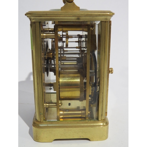 8103 - A brass cased carriage timepiece, with twin barrel movement striking on a gong and gilt coloured pla... 