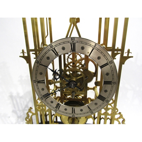 8032 - A cathedral form brass skeleton clock under large glass dome, the silvered Roman numeral chapter rin... 