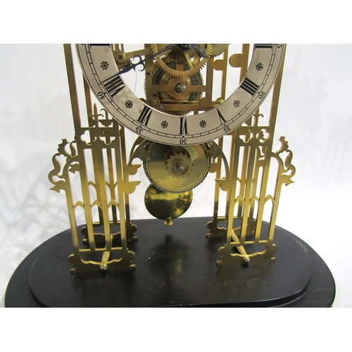 8032 - A cathedral form brass skeleton clock under large glass dome, the silvered Roman numeral chapter rin... 