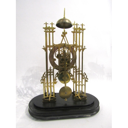 8032 - A cathedral form brass skeleton clock under large glass dome, the silvered Roman numeral chapter rin... 