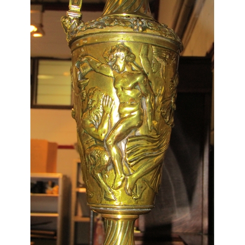 1048 - A large brass jug with figural design on plinth base, 42cm tall