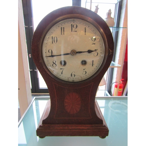 1199 - A brass cased ship's clock and an Edwardian balloon cased mantel clock