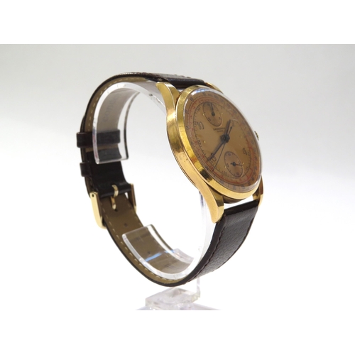 8162 - An 18ct gold cased chronograph wristwatch on leather strap, the gold coloured dial with Arabic numer... 