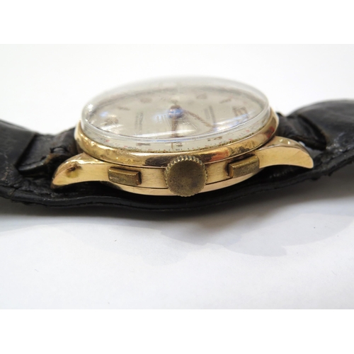 8157 - An 18ct gold cased chronograph wristwatch on a double leather strap, the silvered dial with Arabic n... 