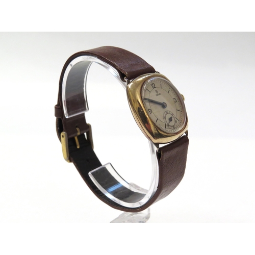 8158 - TUDOR: A 9ct gold cushion cased Tudor wristwatch on a leather strap, the silvered dial with Arabic n... 